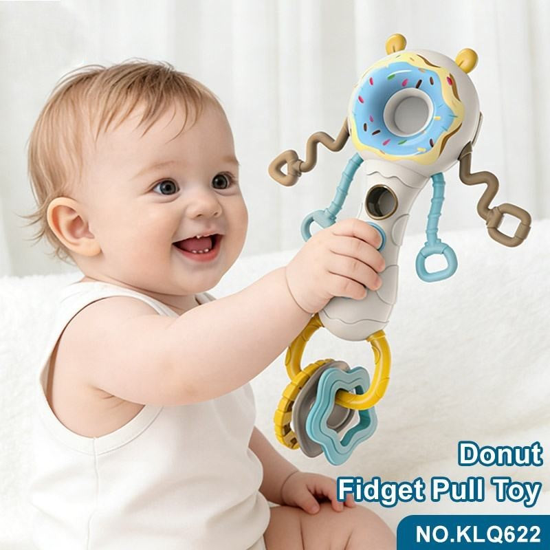 Baby holding Busy Shake the Stick donut fidget pull toy