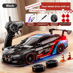 Black 4WD RC drift car with proportional throttle and steering, spare tires and roadblocks