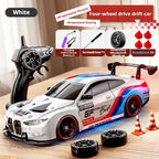 White 4WD RC drift car with interchangeable wheels and remote control